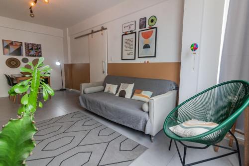 a living room with a couch and a chair in it at Moderno & Prático Centro in Florianópolis