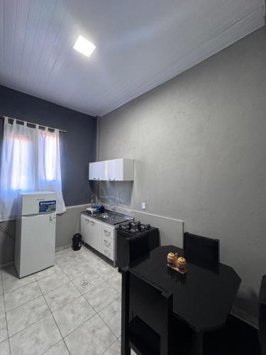 a small kitchen with a stove and a refrigerator at Colar in Oberá