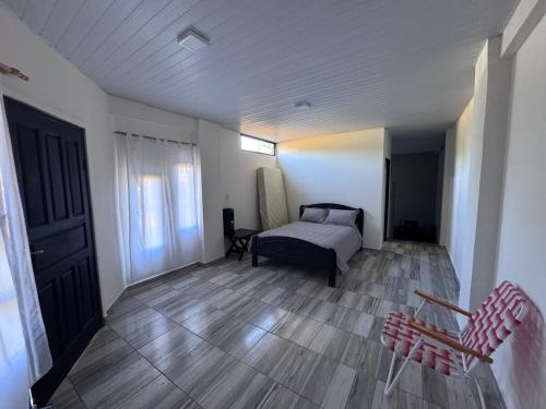 a bedroom with a bed and a wooden floor at Colar in Oberá
