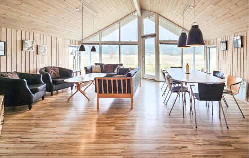 a living room with a table and chairs at Holiday Home Ankersholm Rødby Ii in Rødby