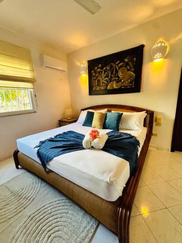 a bedroom with a large bed with two stuffed animals on it at Villa del Sol #1 in La Laguna