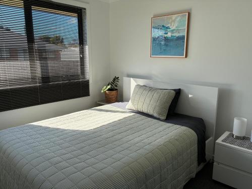 a bedroom with a bed and a window at George Town Central Apartment in George Town