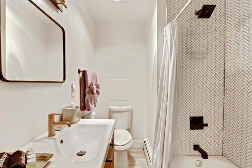 a white bathroom with a sink and a shower at Slopeside Chalet on River Next To WP Resort I Fantastic Views I Private Hot Tub I Gas Firepit I Game Room I Activity Program in Winter Park
