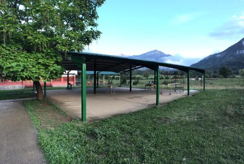 a bus stop with a canopy in a park at Pinarillos in Sarvisé