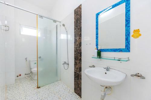 a bathroom with a sink and a glass shower at Homestay 30 Võ Thị Sáu in Vung Tau