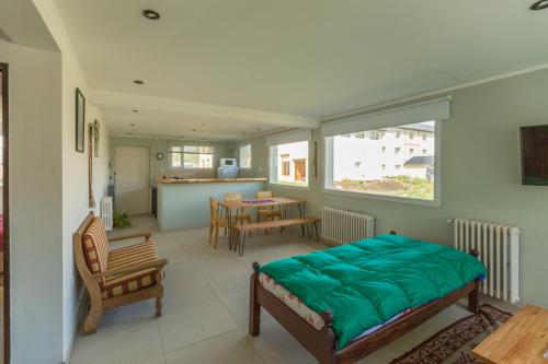 Un dormitorio con una cama y un comedor. en Walwalun, en Caviahue