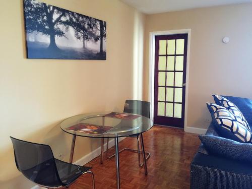 a glass table and chairs in a living room at Downtown 1 Bedroom Apartment 18H in Atlanta