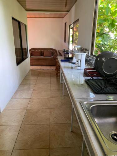 a kitchen with a counter top and a sink at Hospedaje las rocas in Puerto Jiménez