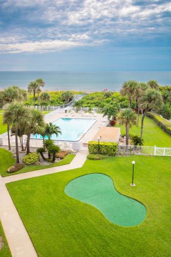 an aerial view of a golf course with a golf ball on the grass at Cocoa Beach Towers - Oceanfront Resort with Heated Pool, Tennis Steps from the Pier in Cocoa Beach