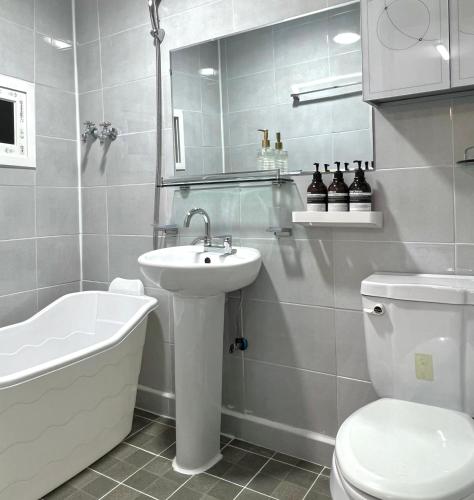 a white bathroom with a sink and a toilet at Private Korean Entire Villa with Garden up to 10 in Seoul