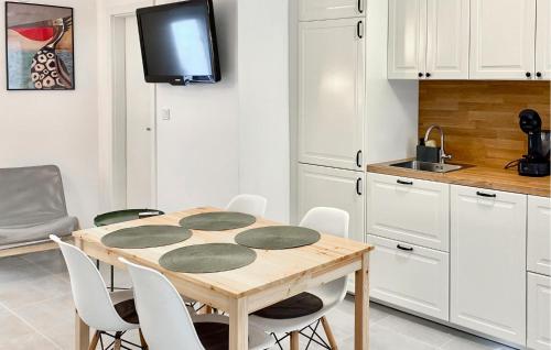a kitchen with a wooden table and white cabinets at Tiana in Vrsar