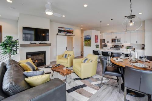 a living room with a couch and a table at Downtown WP Loft 14 I Huge Hot Tub I Great Views I Additional Bunk Area in Winter Park