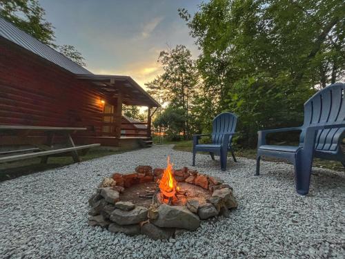 a fire pit with two chairs and a building at Pluggy's Place - Perfect Location - Outdoor Fire pit in Beattyville