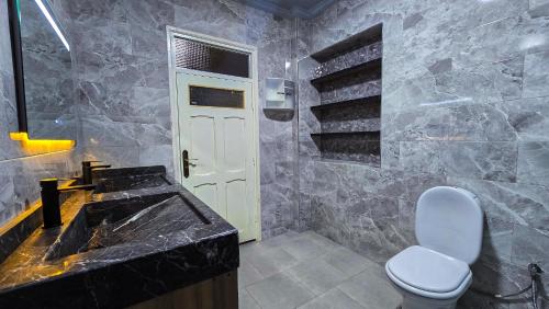 a bathroom with a sink and a toilet at Central Premium Holiday Homes - Marché, Corniche & Océan à pied in Larache
