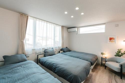 a bedroom with two beds and a window at Grandeur Biei in Biei