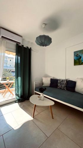 a living room with a couch and a table at 7th Heaven Luxury Villa in Kallithea Halkidikis