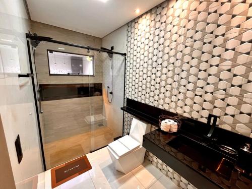 a bathroom with a shower and a toilet at Super comfortable house 3 bedrooms in Paranavaí