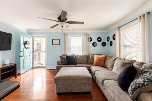 a living room with a couch and a ceiling fan at Cozy Nashville Retreat 10 Min to Broadway in Nashville