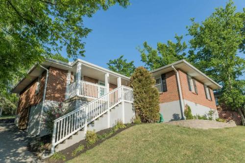 a large brick house with a white balcony at Cozy Nashville Retreat 10 Min to Broadway in Nashville