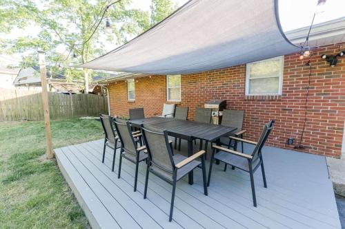 a black table and chairs on a deck at Cozy Nashville Retreat 10 Min to Broadway in Nashville