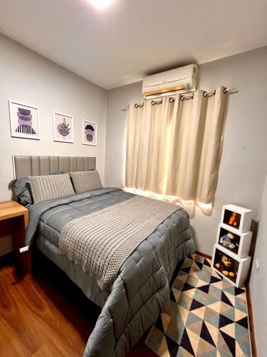 a bedroom with a bed and a window at Super comfortable house 3 bedrooms in Paranavaí