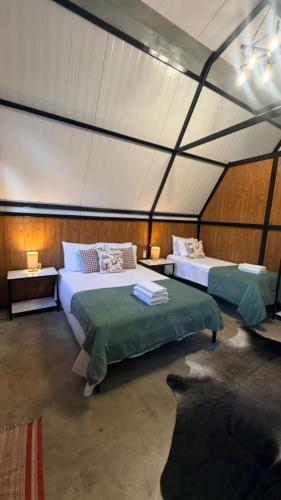 a bedroom with two beds in a tent at Noite Estrelada Hospedagem Rural & Motorhome Park in Holambra
