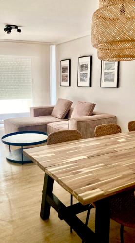a living room with a couch and a table at Piano 8 Sanxenxo in Sanxenxo