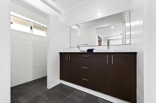 a bathroom with a sink and a mirror at DEAR8 - Madeley Retreat in Perth