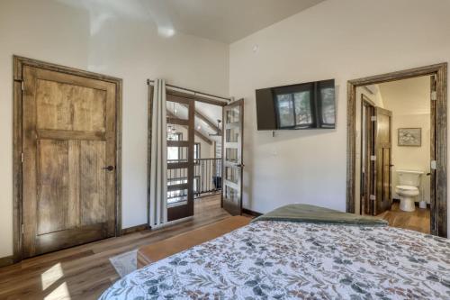 a bedroom with a large bed and a bathroom at The Gold Hill Chalet in Keystone