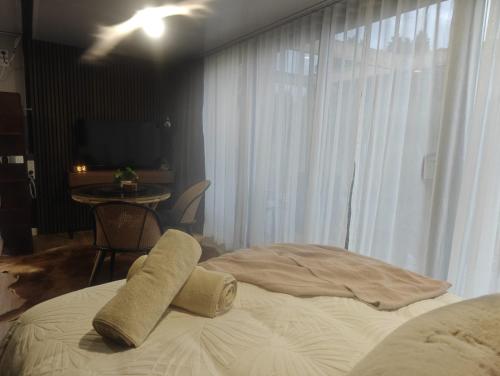 a bed with two pillows on it in a bedroom at Huruhuru Hideaway! Private Cabin in Otatara