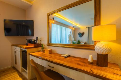 a room with a mirror and a table with a lamp at Coconut Tree Hulhuvilla Beach in Hulhumale