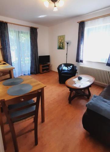 a living room with a table and a couch at Deichblick 02 in Prerow
