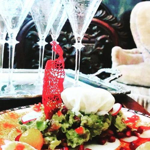 a plate of food on a table with wine glasses at Aaron House of Niagara Falls in Niagara Falls