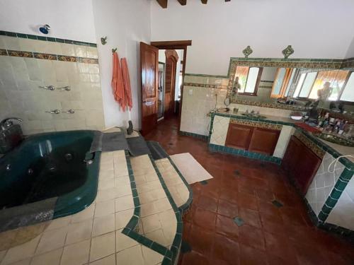 a large bathroom with a tub and a sink at Casa Bella in Puerto Escondido