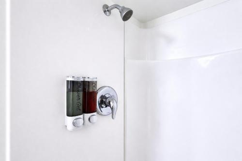 a bathroom with a door with a can opener at The City Center Motel in Medford