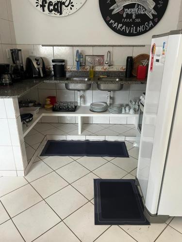 a kitchen with a sink and a counter top at Espaço Familiar com Piscina in São Luís