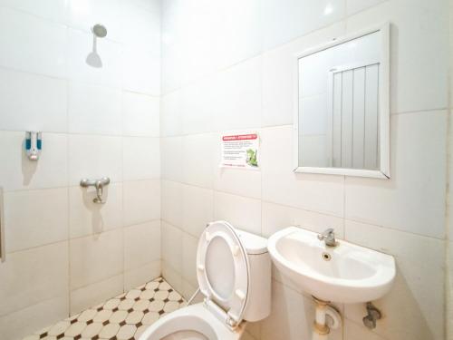 a bathroom with a toilet and a sink at RedDoorz @ Jalan Tanjung Blitar in Blitar