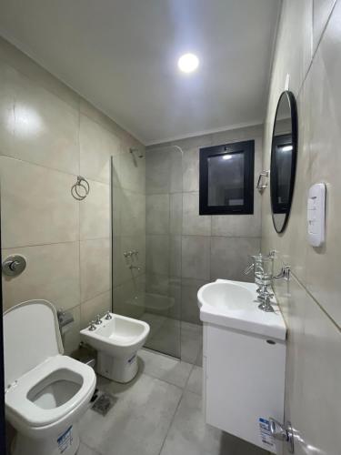 a bathroom with a toilet and a sink and a shower at YOJU aparthotel in Colón