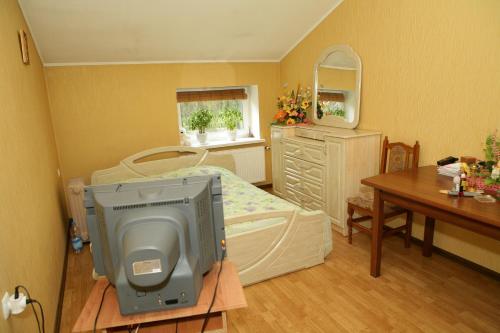 a hospital room with a bed and a table with a television at Hotel Mlyn in Nikolayev