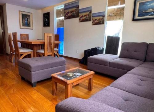 a living room with a couch and a table at Salma in cuzco apart in Cusco