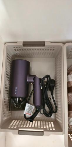 a shelf in a refrigerator filled with cups and cables at #MyPawsomeGetaway, Fun Family Retreat, Tanah Rata, Cameron Highlands in Tanah Rata