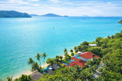 an aerial view of a beach with palm trees and the ocean at Fisherman Way Beach Villa in Rawai Beach
