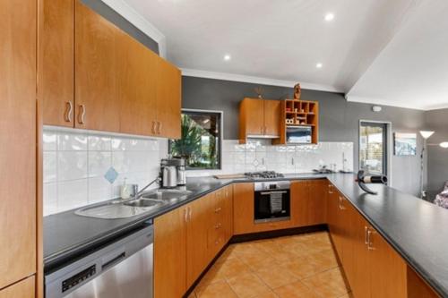 a kitchen with a sink and a counter top at Seasidestyle in Raglan