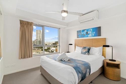 a bedroom with a large bed with a large window at Direct Collective - Pavilion and Governor on Brookes in Brisbane
