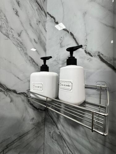 two towels sitting on a towel rack in a bathroom at Casa Bri in Antiguo Cuscatlán