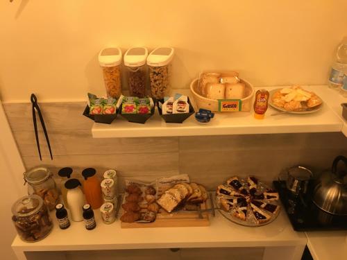 a shelf with food and other food items on it at Morra's Home in Naples
