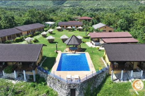 an aerial view of a house with a swimming pool at Seaview Moonrise Café in Alcoy