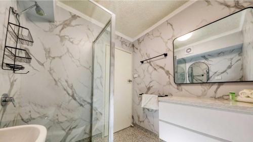 a bathroom with a sink and a mirror at AZA Motel in Lismore
