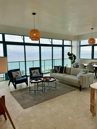 a living room with a couch and a table at JUAN DOLIO 2BR Beach front SALITRE across Club Hemingway in Juan Dolio