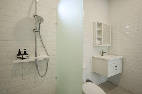 a bathroom with a shower and a toilet and a sink at Polly Canggu 1BR Private Pool Villa By Bali Bliss Properties in Buduk
